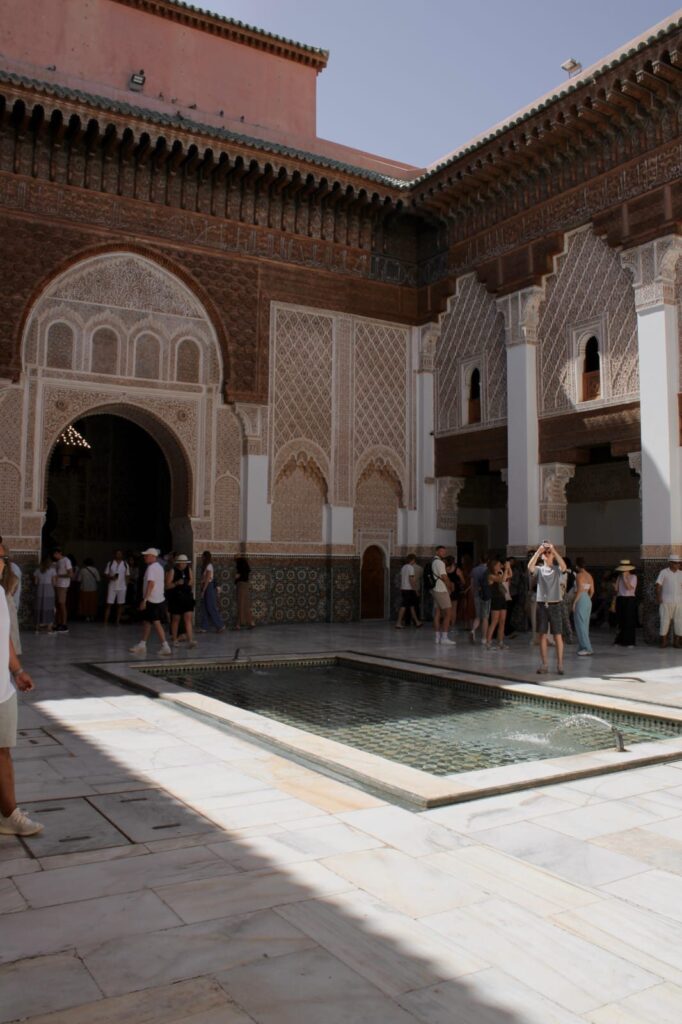 Courtyard pool and carved stucco walls of the Ben Youssef Madrasa, Marrakech